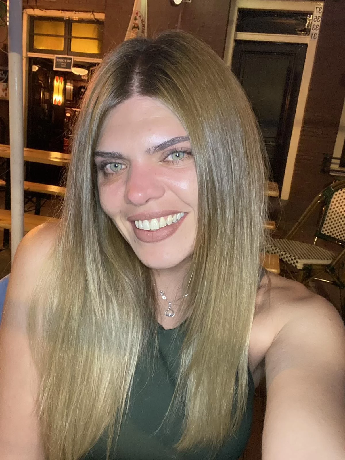woman with long blonde hair smiling at the camera