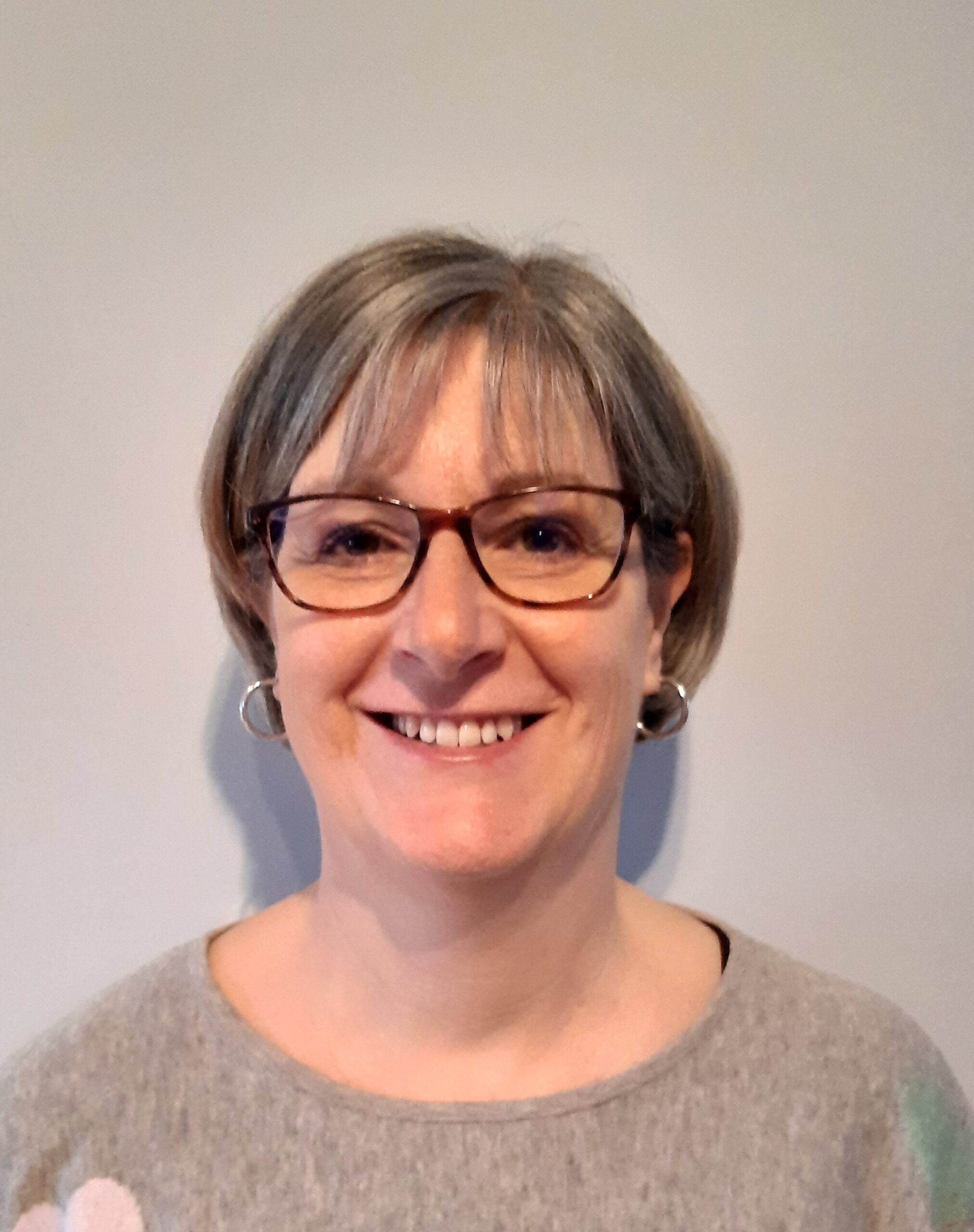 middle aged woman smiling for a camera selfie