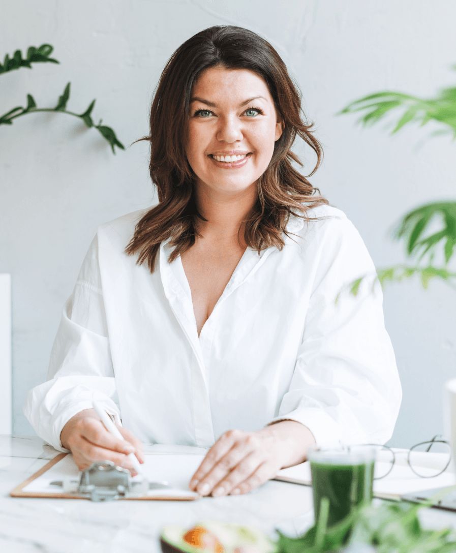 A nutritional therapist at a table with a clipboard