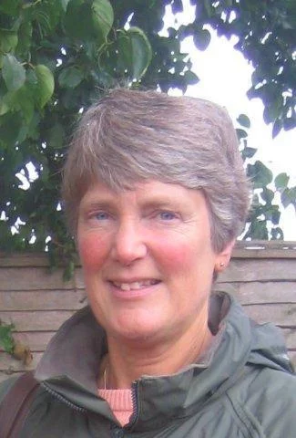 middle aged woman taking a selfie in a natural landscape