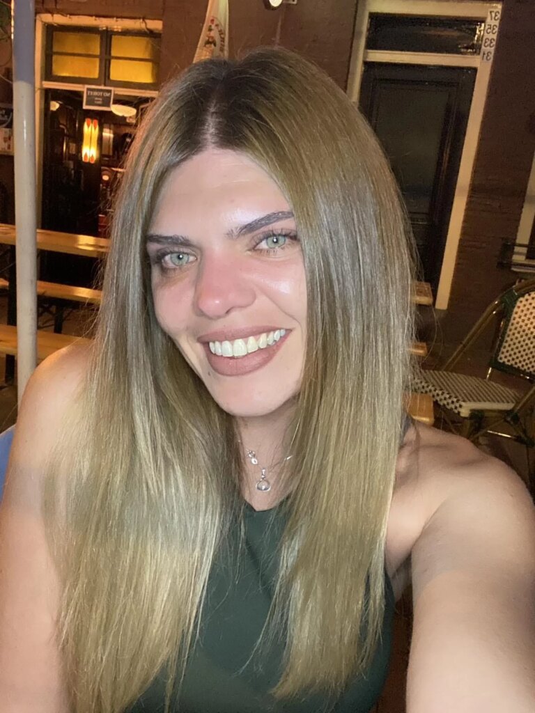 woman with long blonde hair smiling at the camera