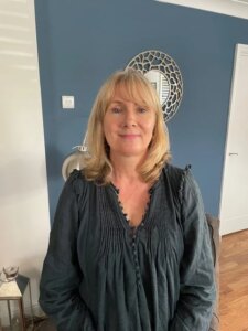 middle aged blonde woman smiling at the camera