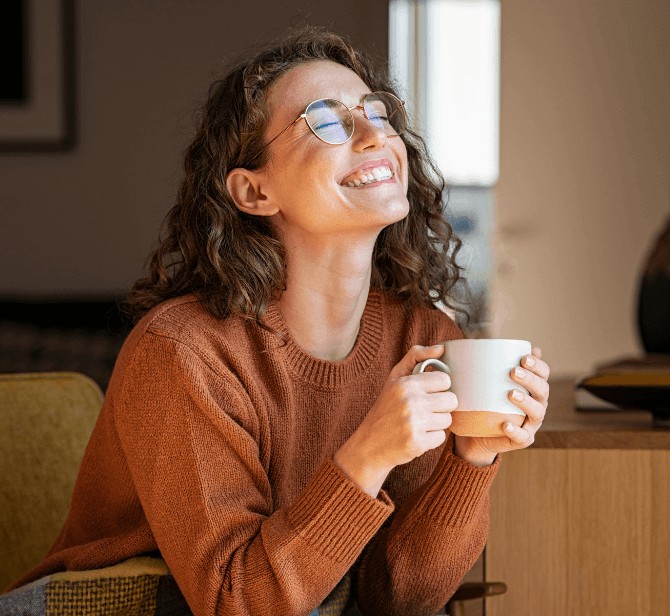 Woman smiling holding coffee new