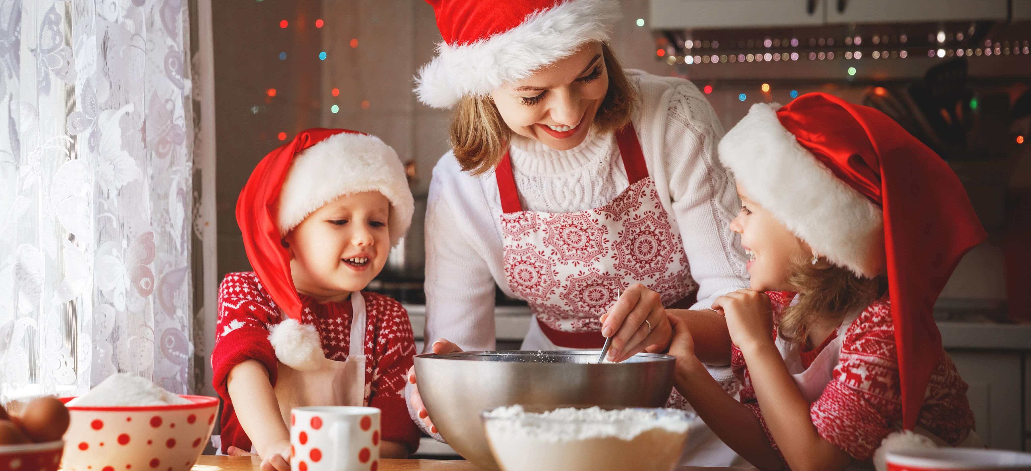 A mother and her two children baking cookies for Christmas