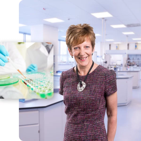 Dr Gill Hart dressed smart and smiling at the camera in a laboratory