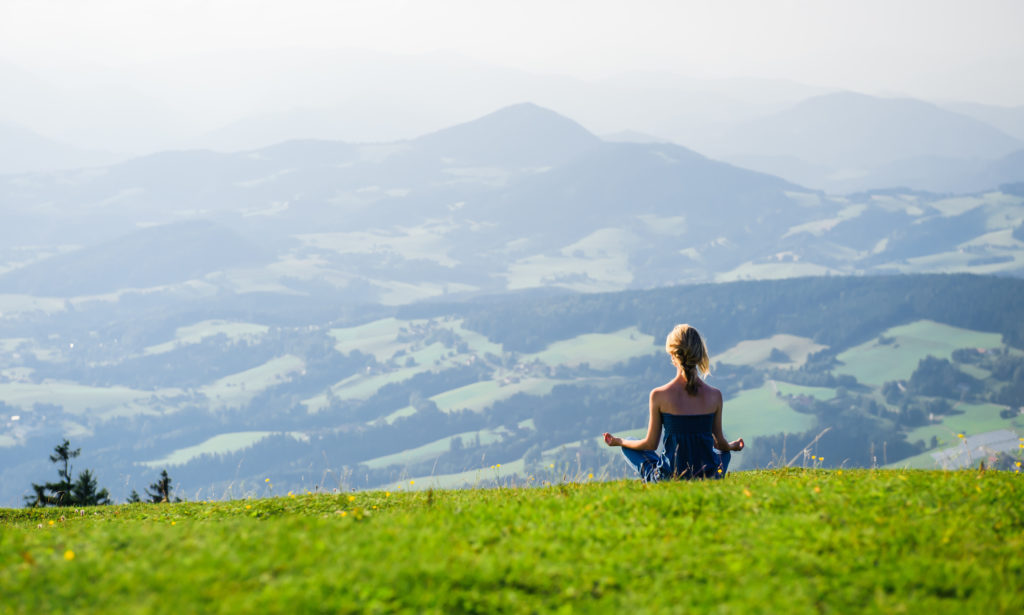 women meditating outside