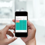 YorkTest Premium Food Intolerance Test results featured on the screen of an android phone which is in turn held by a man's pair of hands.