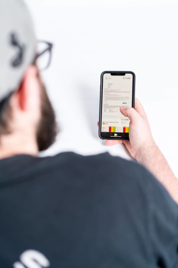 man looking at his yorktest results on a mobile device