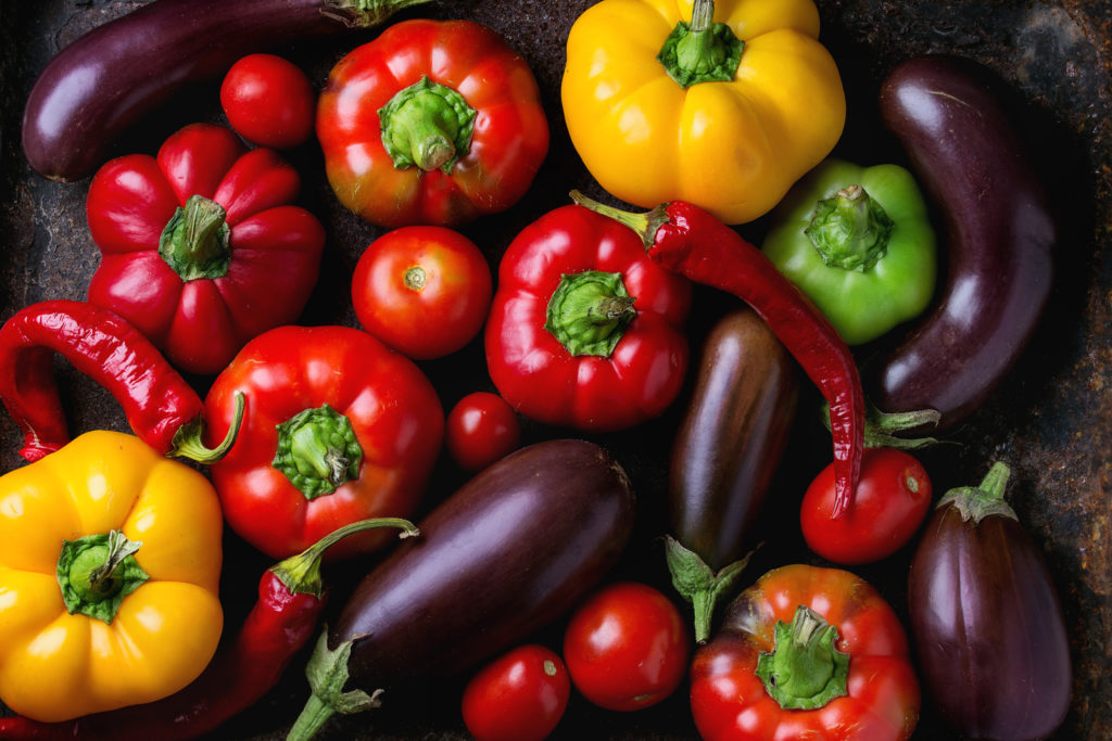 a variety of vegetables including peppers and aubergines