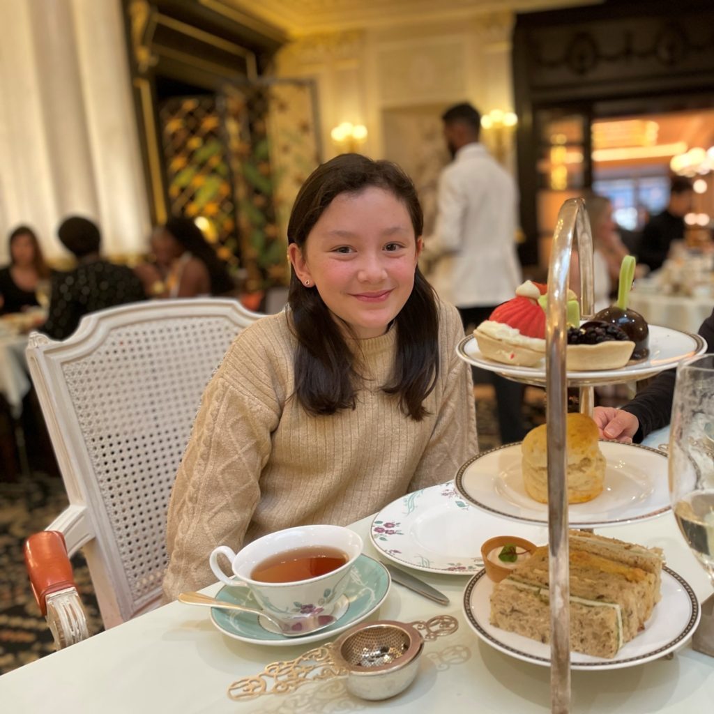 young girl having afternoon tea in a restaurant