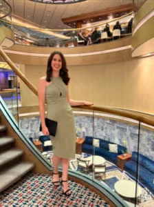 young woman in a light green dress posing for the camera in an elegant venue