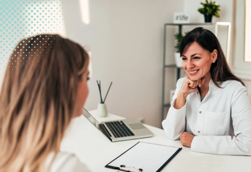 Nutritional Therapist giving a patient consultation in a bright, clean office