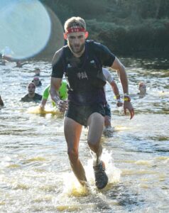 ultra marathon runner running out of the water
